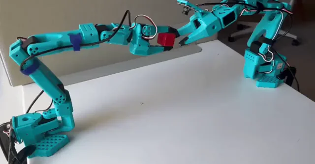 SO100 Robot Arm in action - leader and follower configuration demonstrating teleoperation